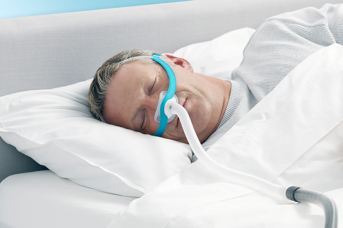 Man sleeping on side wearing Evora nasal cpap mask