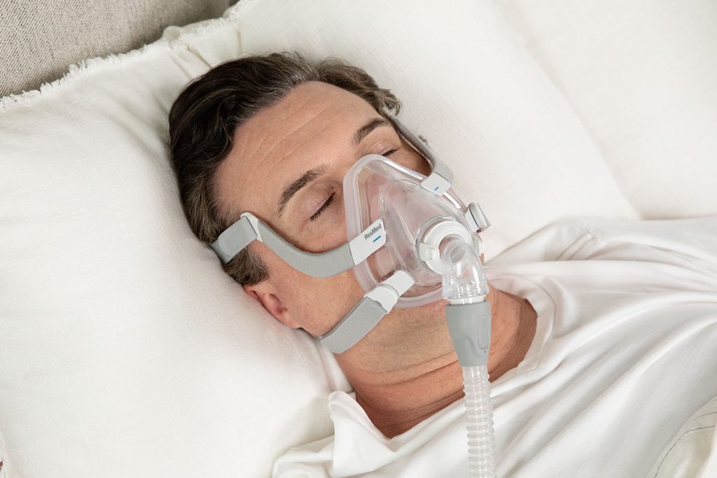 Man sleeping soundly wearing AirFit F20 cpap mask