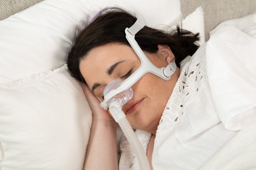 woman sleeping soundly wearing airfit n20 cpap mask