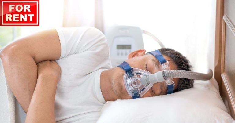 Image of a man using a CPAP he rented instead of buying and owning
