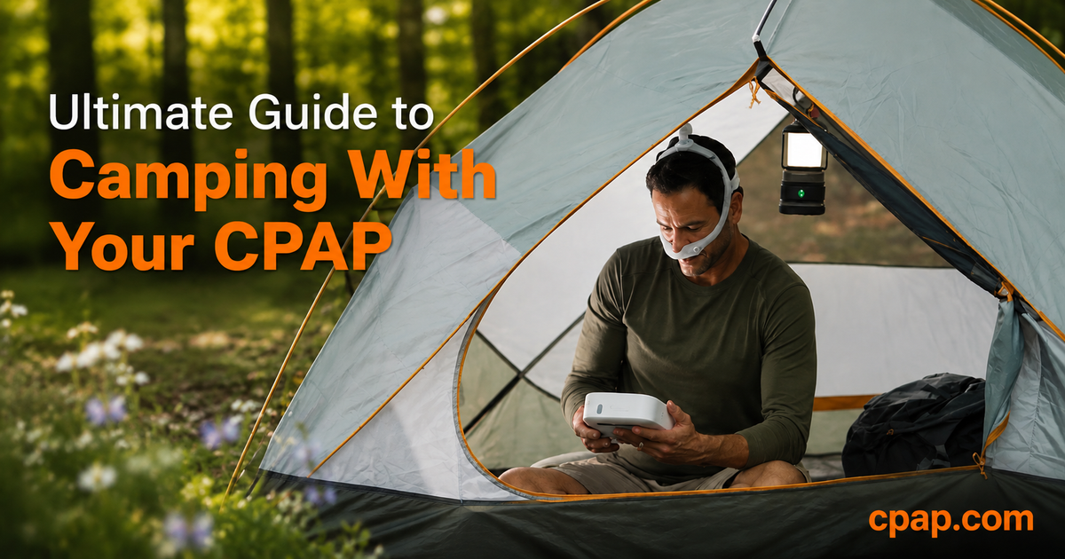 A man is wearing a CPAP Mask, looking at a machine while in a tent.