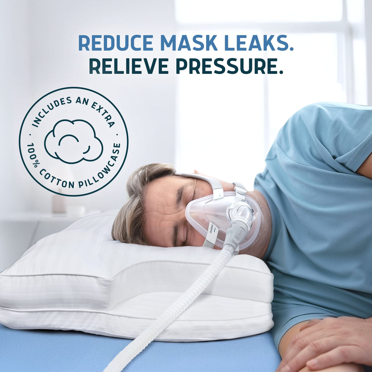Man sleeping on a white Lunderg CPAP pillow while wearing a full face CPAP mask.
