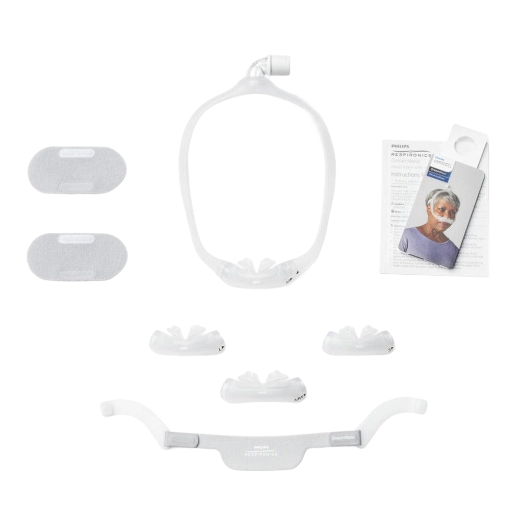 Image showing each part of the fit pack - includes the dreamwear mask frame, tubing elbow, optional fabric wraps, headgear, user manual, and four cushion sizes - small, medium, medium wide, and large.