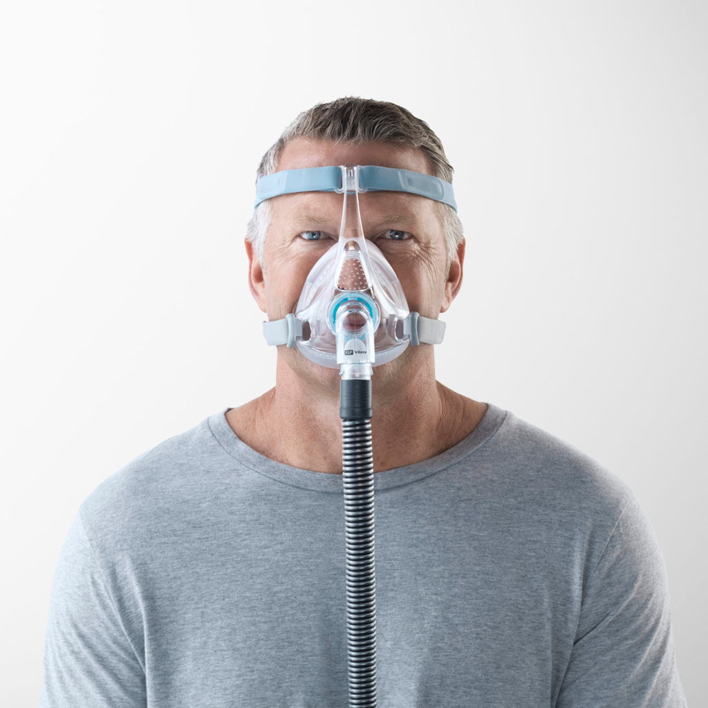 man wearing f&p vitera full face cpap mask, facing the camera