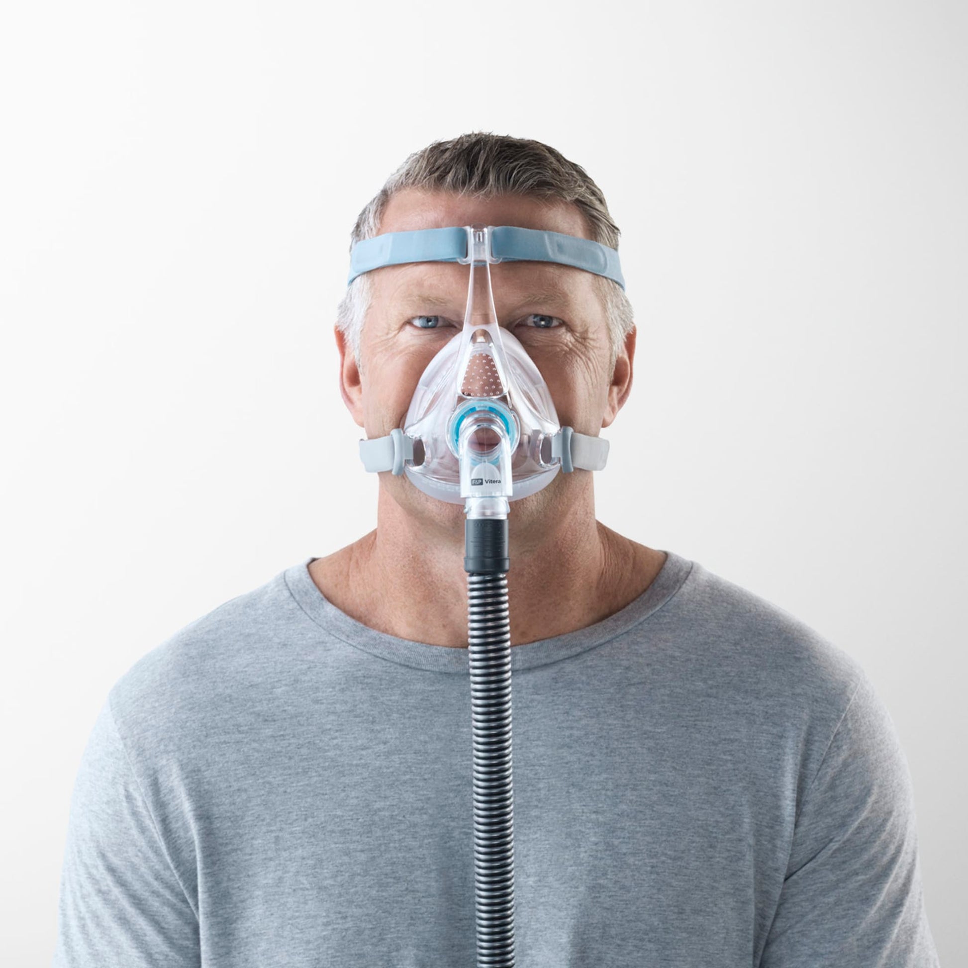 man wearing f&p vitera full face cpap mask, facing the camera