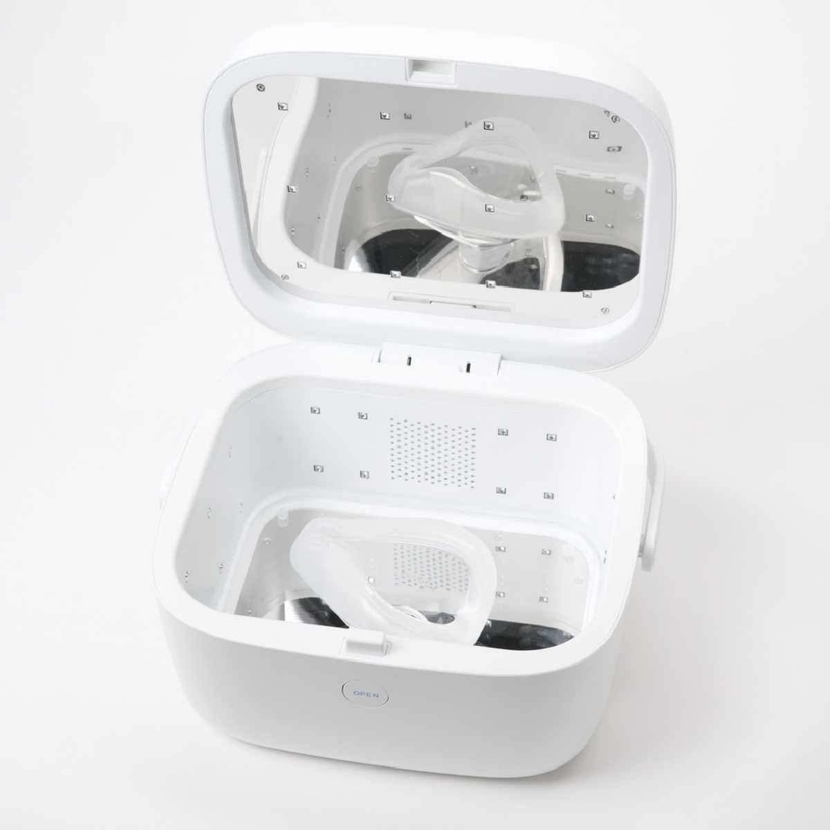 LiViliti Paptizer 360 white microbial reduction device open with a CPAP mask inside.