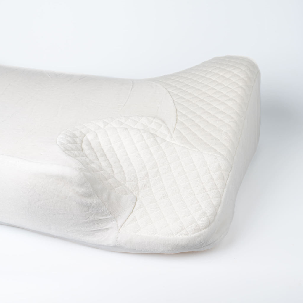Close-up of Snugell Memory Foam CPAP Pillow, showing quilted texture and ergonomic cutouts for mask and tubing placement.