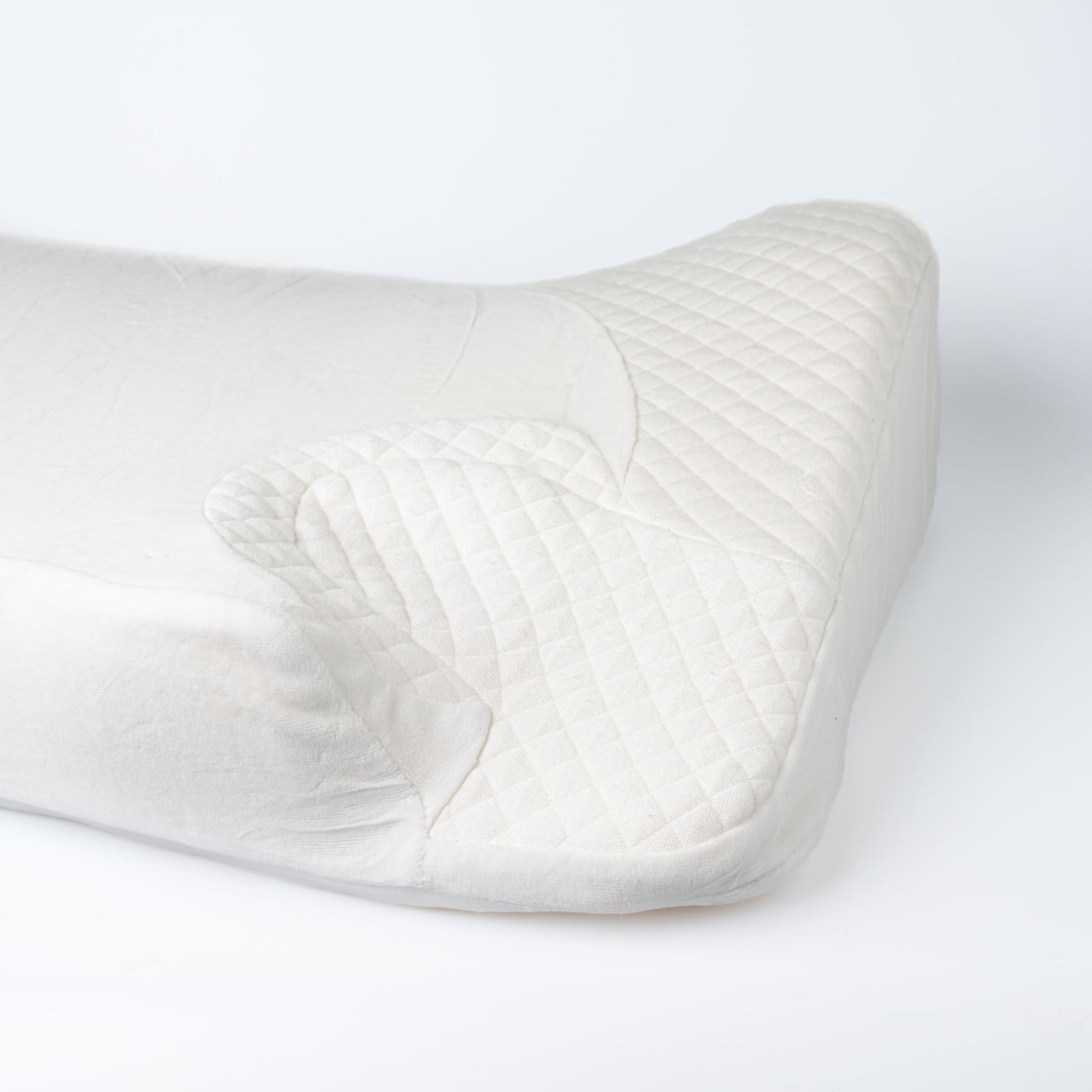 Close-up of Snugell Memory Foam CPAP Pillow, showing quilted texture and ergonomic cutouts for mask and tubing placement.