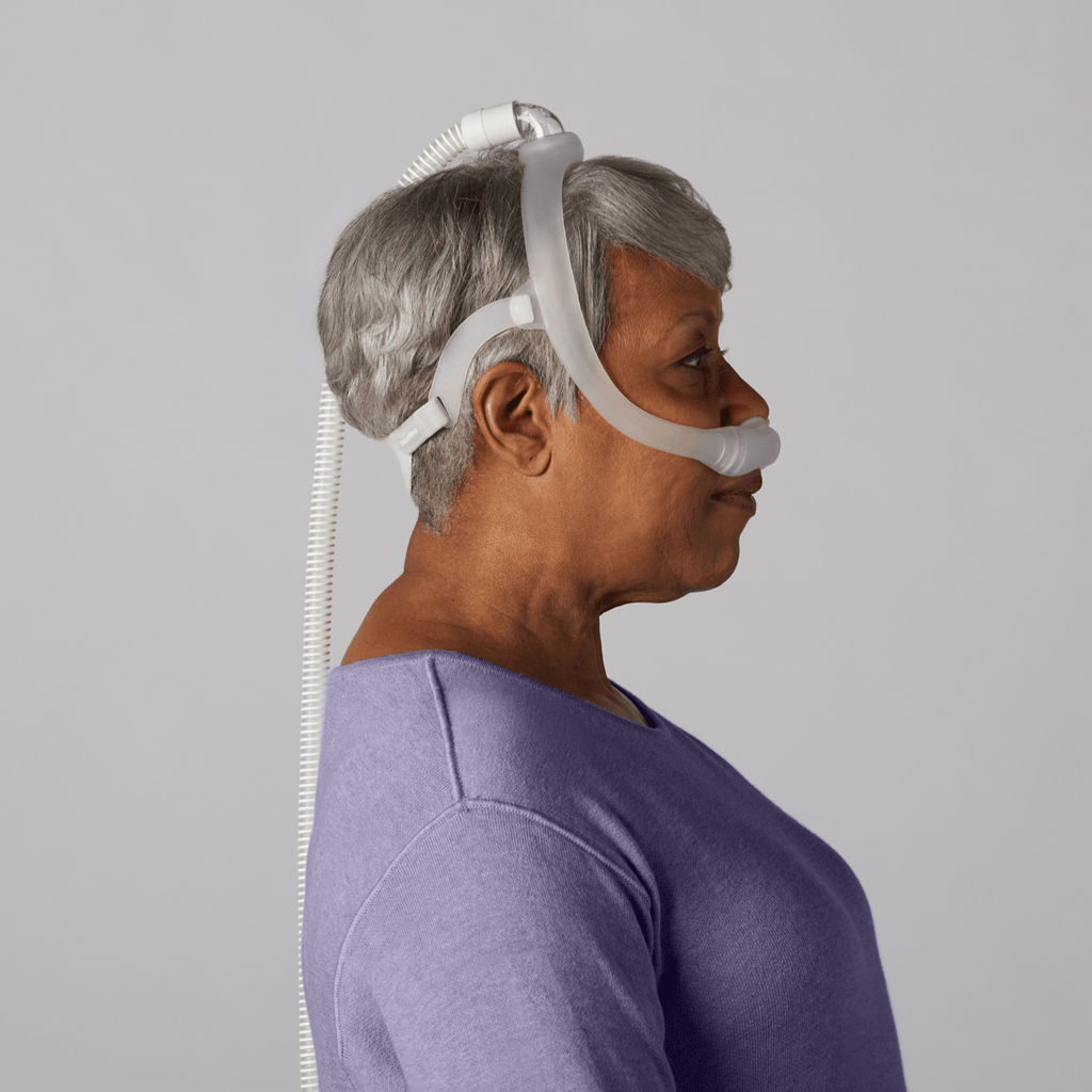 side profile of a woman wearing the dreamwear nasal pillow cpap mask
