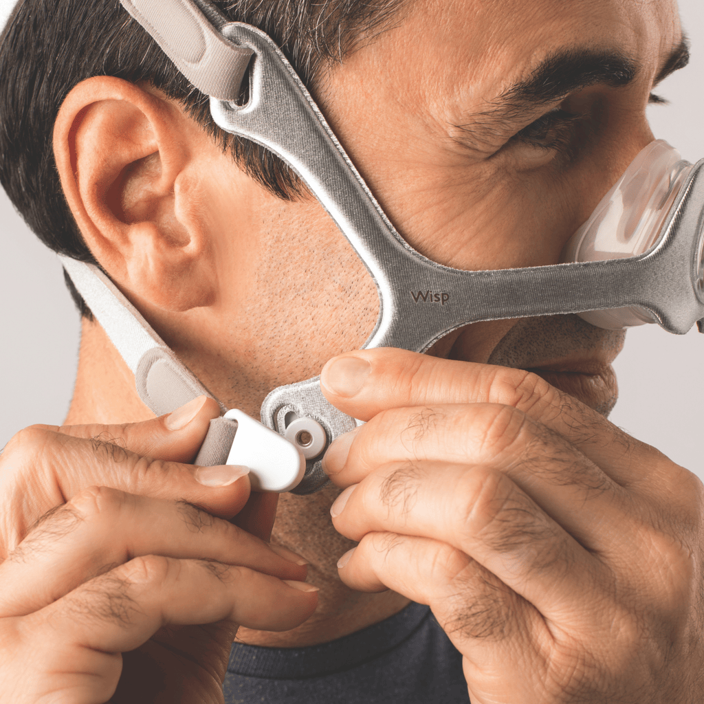 man wearing wisp nasal mask with fabric frame connects the magnetic headgear clips
