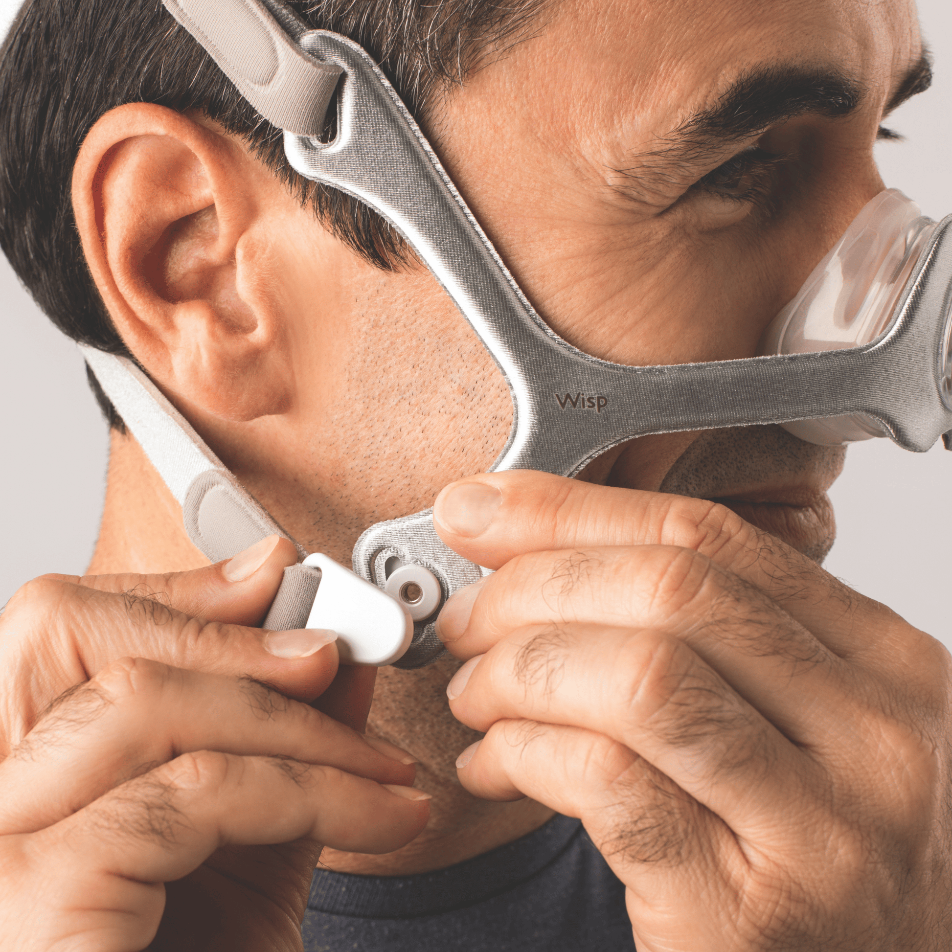 man wearing wisp nasal mask with fabric frame connects the magnetic headgear clips