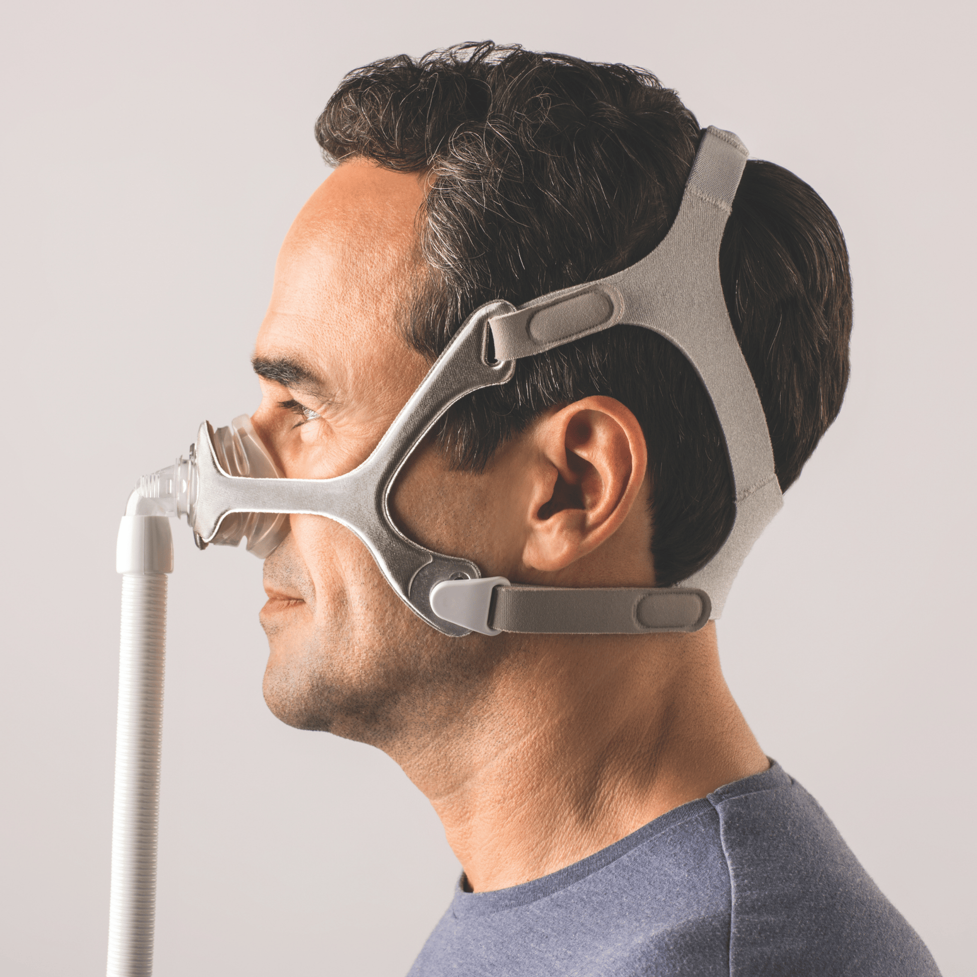 man shown from the side profile wearing wisp nasal mask with fabric frame